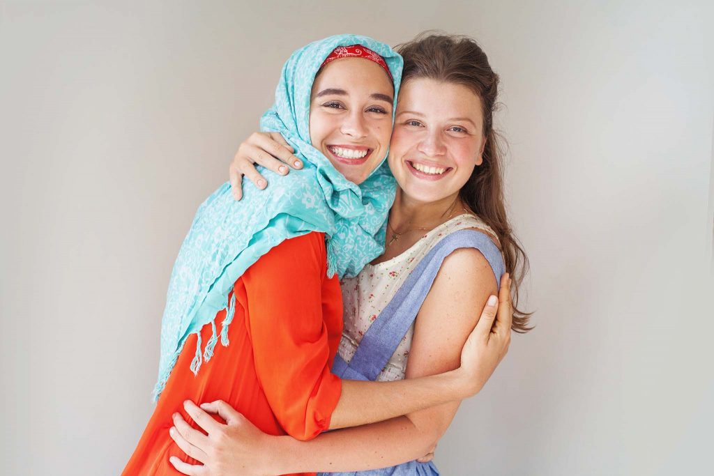 Two smiling women hugging