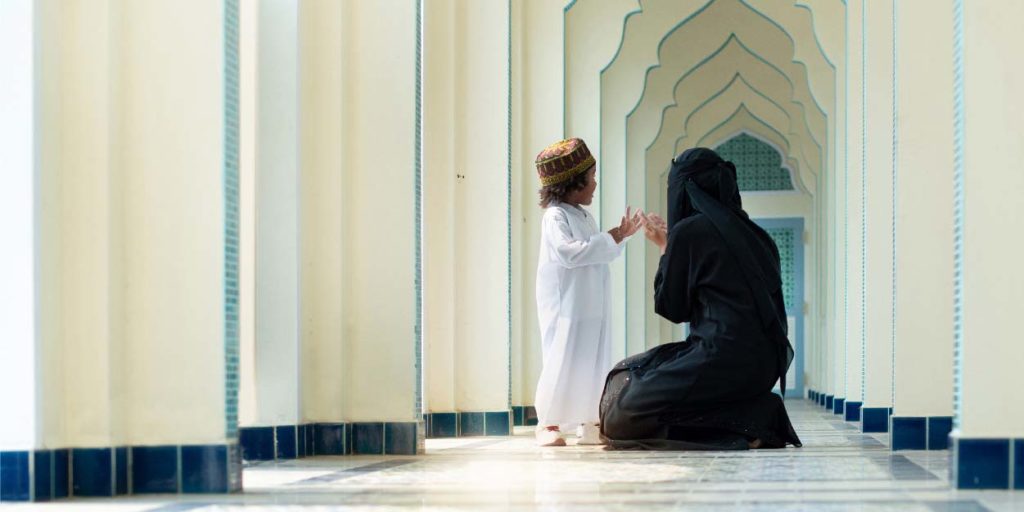 woman in chador garment talking to child